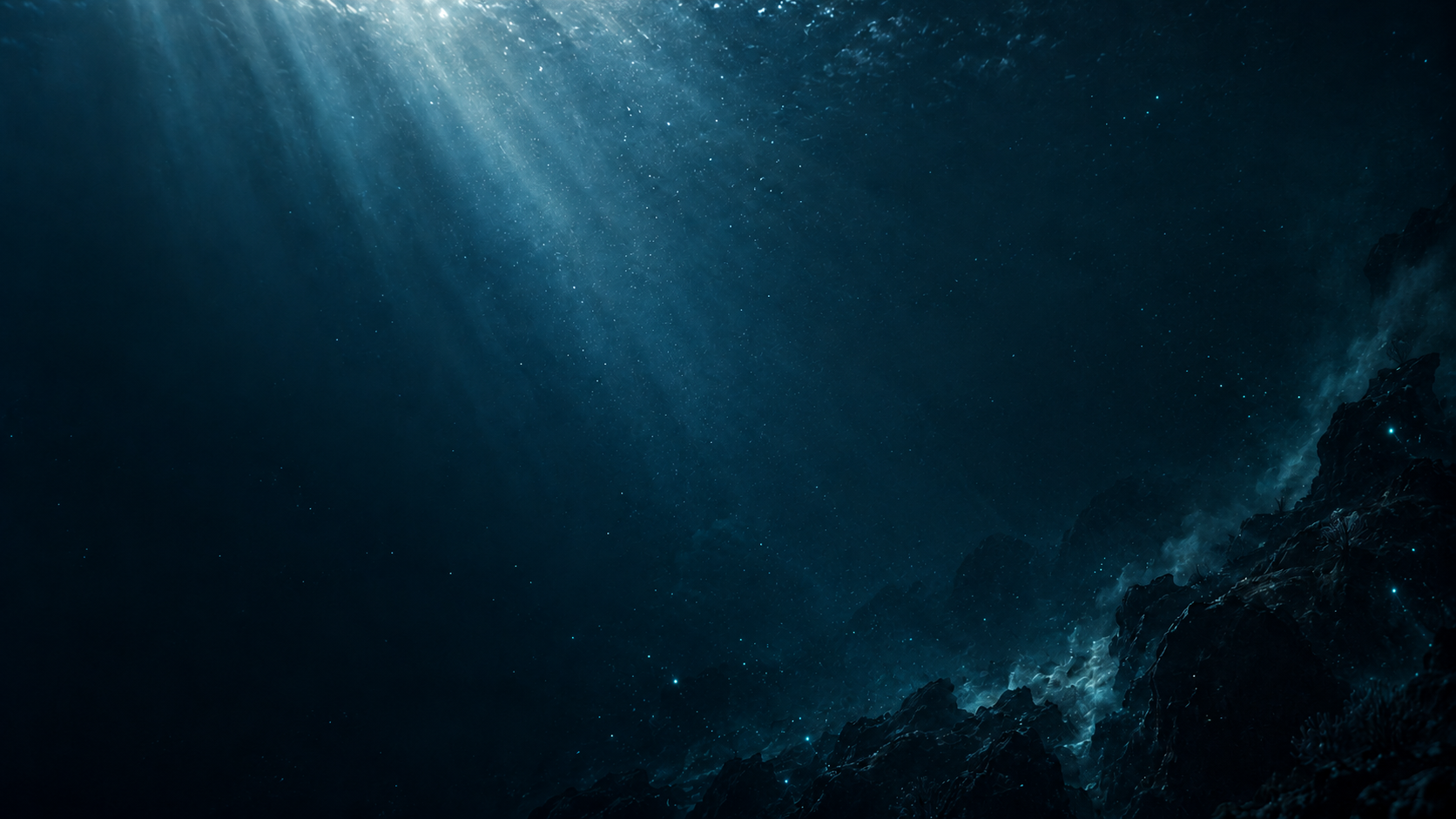 Light fading into dark water above the distant seabed